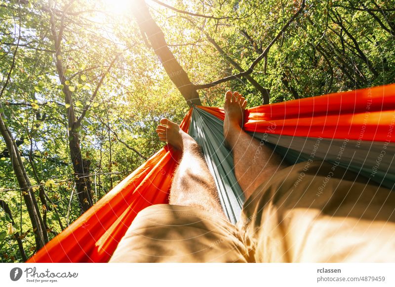 relaxing in the hammock at summer garden man outdoor wood camping travel holiday resort senior happy sun backpack hipster abstract beach beautiful enjoy