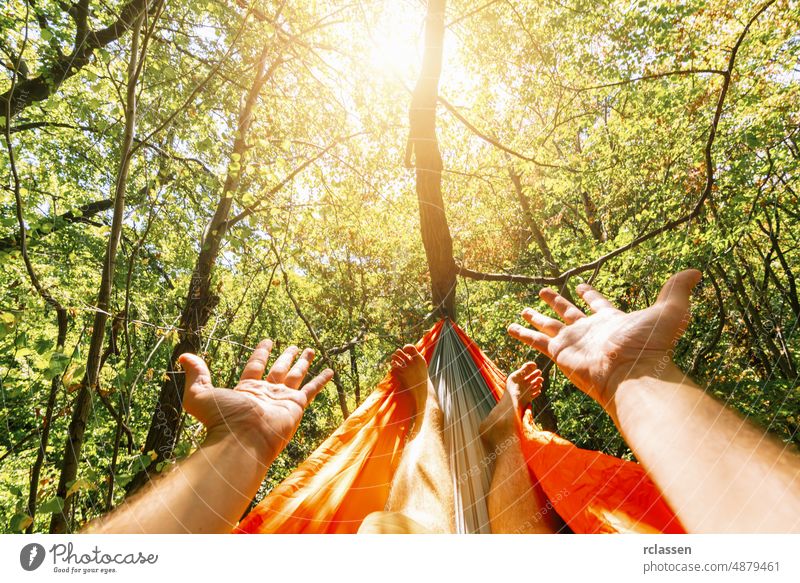 relaxing in the hammock at summer garden man outdoor wood camping travel holiday resort senior happy sun backpack hipster abstract beach beautiful enjoy