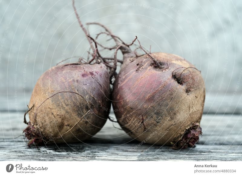 Two beet tubers against gray background Red beet beetroot superfood Vegetable Two tubers 2 Vegan diet Vegetarian diet Food Bulb crimson Root vegetable vitamins