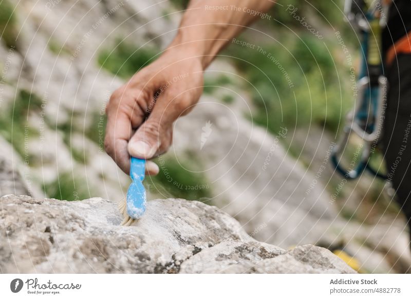 Closeup Of Hand Cleaning Rock With Brush Hiker Preparing Climbing Male Climber Hiking Adventure Activity Travel Exploration Vacation Trekking