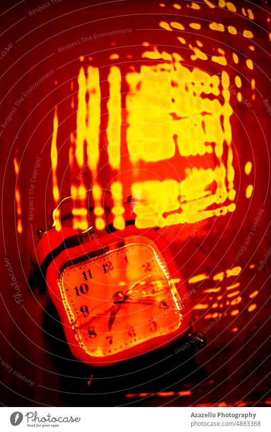 Abstract inferno background in red and orange with a clock. blurry motion blurred illusion hallucination concept minimalism conceptual abstract art fine art