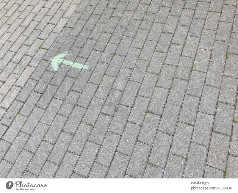 Arrow to the left on paving stones pavement off Left Street Lanes & trails Paving stone Traffic infrastructure Structures and shapes Sidewalk Deserted