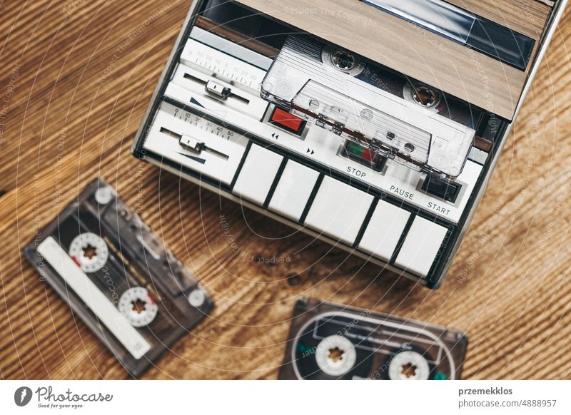 old audio technology, compact music cassette with text - disco, on a large  amount of magnetic tape. Magnetic tapes background, realistic retro design  - a Royalty Free Stock Photo from Photocase