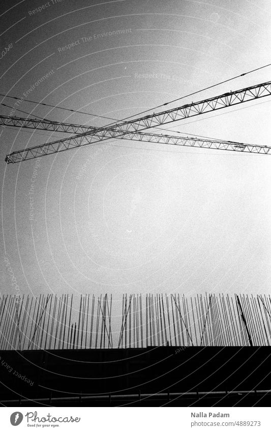 Steel vertical and semi-diagonal Analog Analogue photo B/W Black & white photo Construction site Reinforcement Concrete Crane rods Crossed Exterior shot
