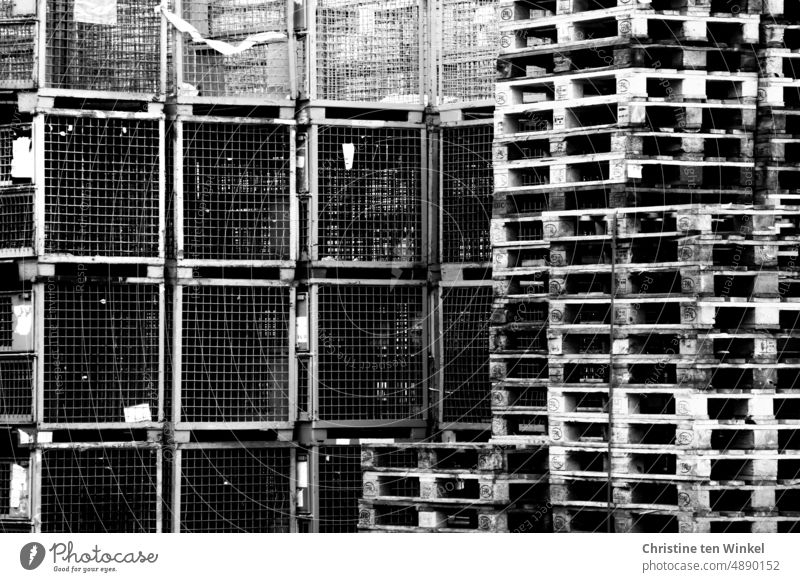 Stacked wooden pallets and metal mesh boxes waiting for goods Palett pallet stacks Wooden pallets Empty Industry Box pallets Metal mesh boxes logistics Storage