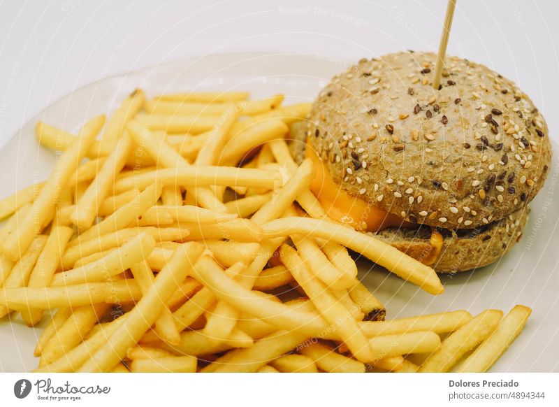 A cheeseburger and fries ideal for a children's menu american background beef bread bun classic closeup delicious diet dinner eat fast fastfood fat french