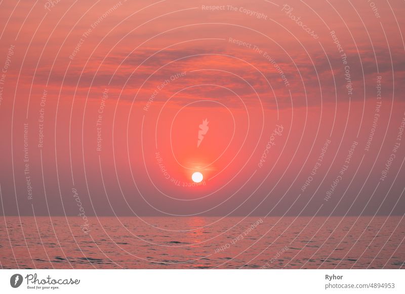 Sundown Above Sea Horizon At Sunset. Natural Sunrise Sky Warm Colors Over Ocean. Sun Over Sea Waters beautiful bright calm color copy space evening horizon hot