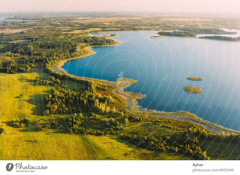 Braslaw Or Braslau, Vitebsk Voblast, Belarus. Aerial View Of Nedrava Lake, Green Forest And Meadow Landscape In Sunny Autumn Morning. Top View Of Beautiful European Nature From High Attitude. Bird's Eye View. Panorama. Famous Lakes. Natural Landmarks