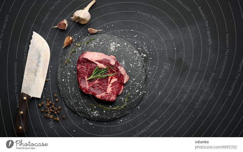 https://www.photocase.com/photos/4895702-raw-beef-tenderloin-lies-on-a-cutting-board-and-spices-for-cooking-on-a-black-table-top-view-photocase-stock-photo-large.jpeg