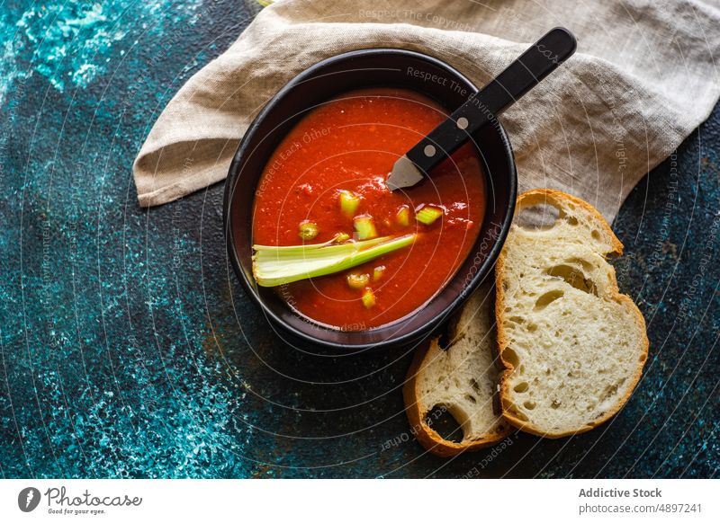 Tomato soup with cerely eat food fresh gazpacho lunch meal stick stone table tomato vegetable vegetarian bowl culinary red natural spice recipe cuisine cold