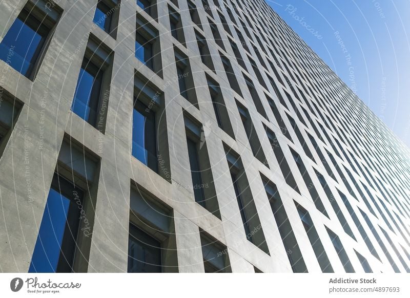 Exterior of contemporary multistory building house facade design urban street architecture city modern sunshine sunlight sunbeam blue sky complex office