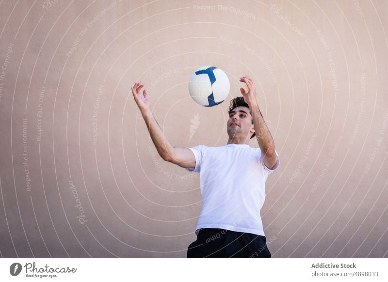 Young Male Player Practicing Football Soccer Wall Beige Motion Court Ball Athlete Game Playing Copy Space Sport Soccer Player Fitness Competition Action