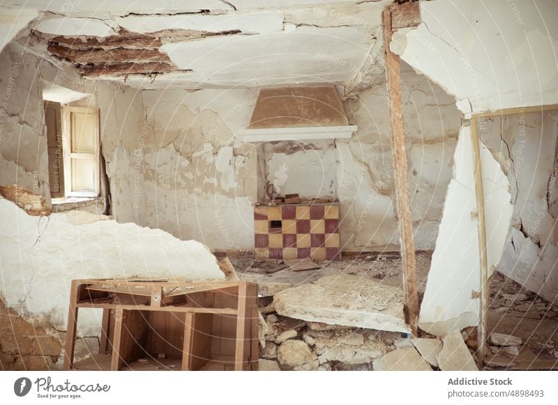 Interior of broken abandoned house room interior furniture sunlit daytime wall rough daylight residential structure sunlight dwell aged construction desolate