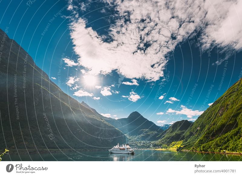 Geirangerfjord, Norway. Touristic Ship Ferry Boat Cruise Ship Liner Floating Near Geiranger In Geirangerfjorden In Sunny Summer Day. Famous Norwegian Landmark And Popular Destination.