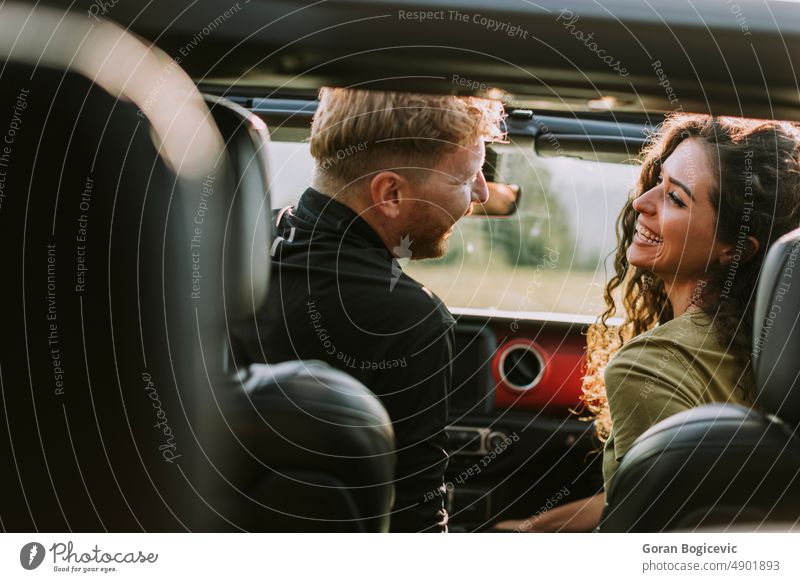 Couple having fun on roadtrip couple woman two vehicle automobile car together nature transport lifestyle driver travel male love young happy togetherness guy