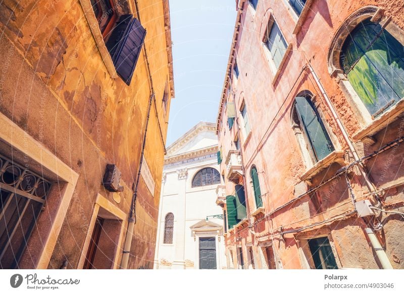 Old buildings in the city of Venice in Italy bright facade day scene venezia village summer retro colors ancient concrete construction medieval texture stone