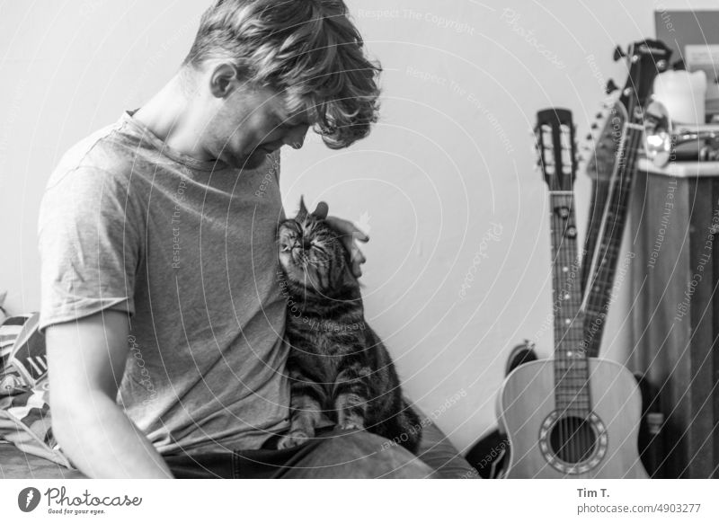 Young man with cuddling cat Cat hangover cuddle bnw b/w Guitar Day Black & white photo