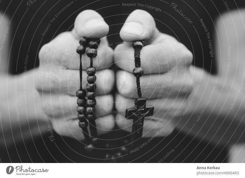 Man hands hold a rosary Male Hands Rosary praying hands To hold on Prayer hold. hold tight Religion and faith Retentive Spirituality Belief Hope Close-up