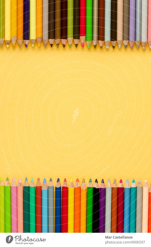 Back to class. Coloured pencils on yellow background. Copy space. Vertical photo. Back to school envelope Top view copy cream pastel education primary secondary
