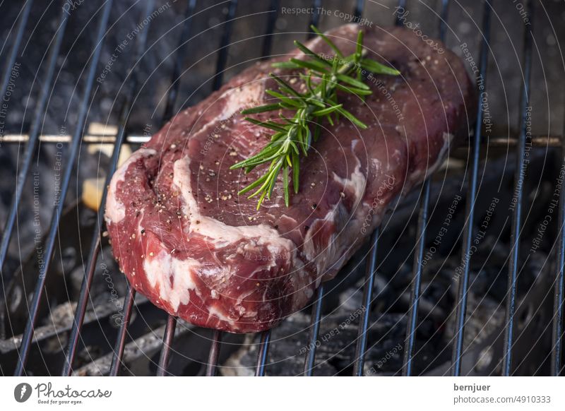 Raw steak with rosemary on the grill Steak Smoke Fat Rust Barbecue (apparatus) Meat BBQ Eating boil grilled Fire Flame roasted Rosemary background Close-up Meal