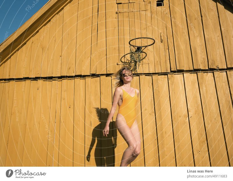 A gorgeous blonde girl dressed in a yellow swimsuit enjoys a perfect summer’s day in the countryside. Freedom blue. Energizing yellow. And all the colors you need to support the Ukrainian people right now. Slava Ukraini, Heroyam Slava!