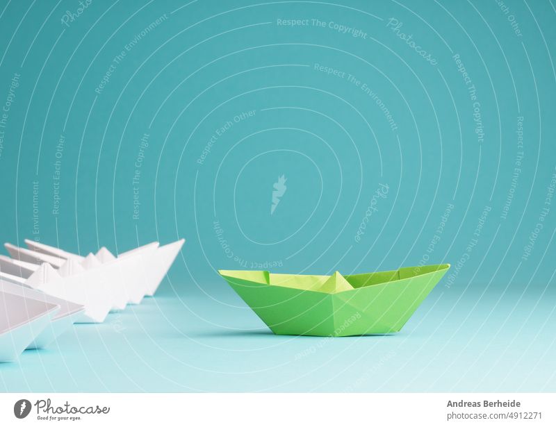 New ideas, creativity and various innovative solutions or leadership, ecology concept with paper boats green environment white business color compass