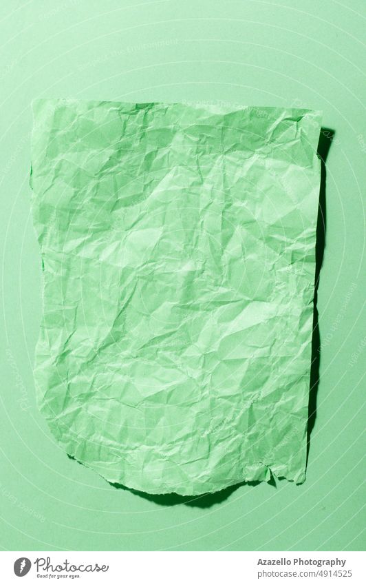 Minimal still life image of a crumpled piece of green paper. abstract art artistic backdrop background bright chaotic color colorful concept cracks creative