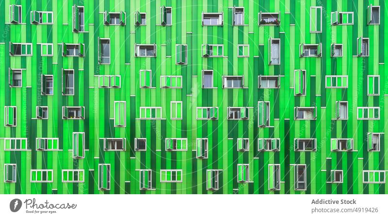 Modern green building with opened windows background facade modern architecture abstract vivid contemporary part design style detail element fragment geometry