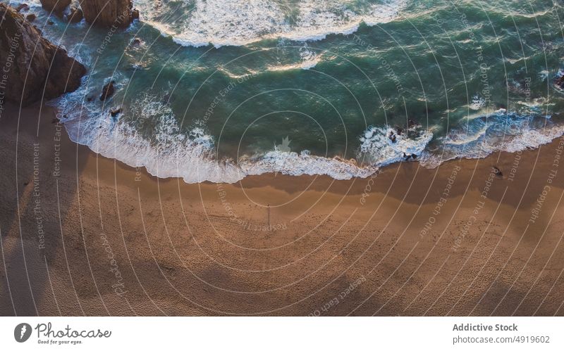 Shore near sea with cliffs at sunset time wave rock beach water shore nature coast island tropical evening sundown summertime sunlight sand resort seashore