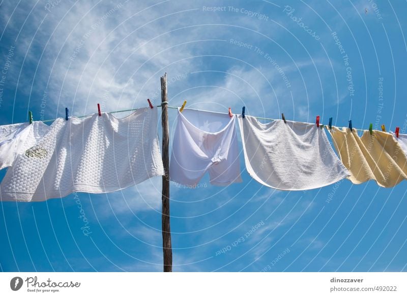 Laundry drying on the rope outside on a sunny day Sun Rope Air Sky Wind Clothing T-shirt Shirt Pants Underwear Line Hang Fresh Bright Clean Blue Red White