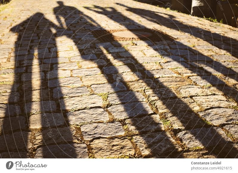 Shadow of four people in evening light Light Exterior shot House (Residential Structure) evening mood Manmade structures Sunlight Yellow Colour photo Dusk