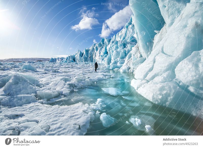 Traveler admiring spectacular scenery of frozen seashore winter person ice hike traveler hiker landscape beach cold glacier iceland admire explorer coast