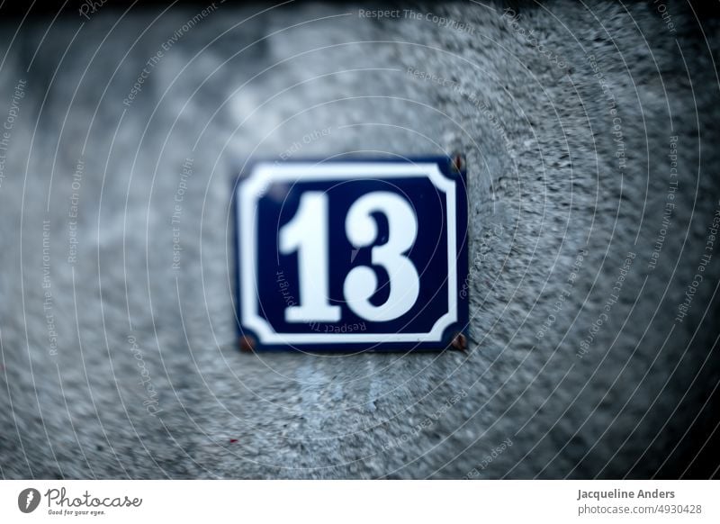 white house number 13 on blue sign in Freelens House number Signs and labeling freelens Blue White Digits and numbers Wall (building) Exterior shot Colour photo