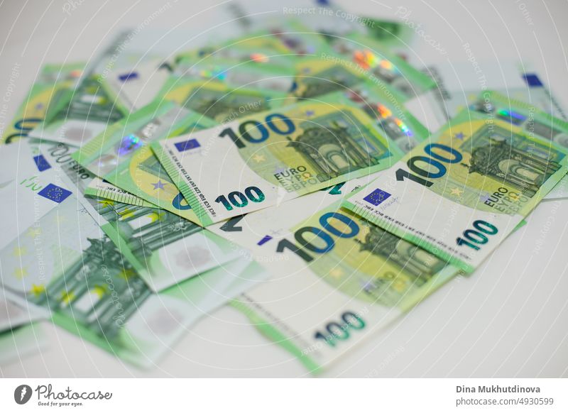Pile of green 100 (one hundred) euro banknotes closeup. Inflation in European Union concept. Money on white surface isolated. Pile of one hundred euro notes. Cash payments concept.