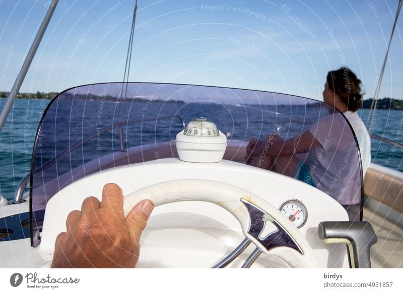 Ride in a motorboat on a lake. Cockpit with compass and steering wheel Motorboat Watercraft Boating trip Steering wheel Compass (Navigation) driver's cab Hand