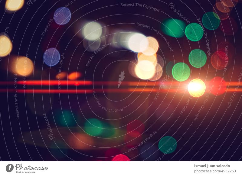 street lights in the city at night colors colorful multicolored bokeh circles bright shiny blur blurred defocused outdoors abstract pattern background textured