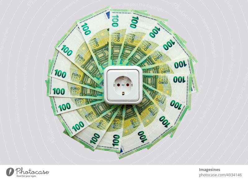 Socket and euro bills placed in the shape of a circle. Concept of saving electricity at home. Euro banknotes. Electricity costs and expensive energy concept