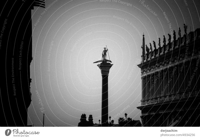 On a large column, in St. Mark's Square in Venice stands the San Teodoro. St. Marks Square Exterior shot Italy Tourist Attraction Historic Old town Deserted