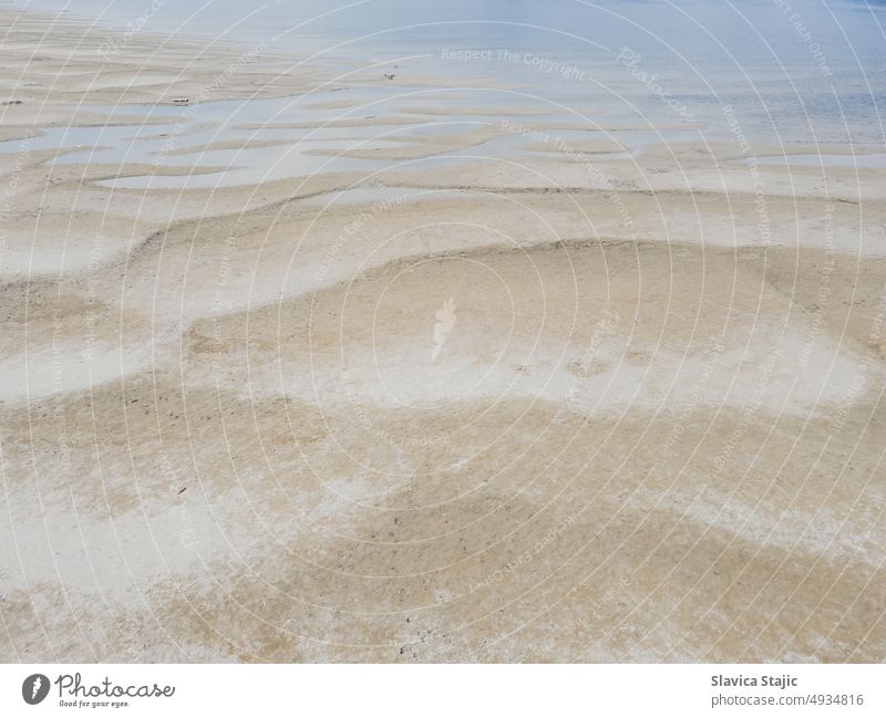 The sandy bank of the Danube River. Background of sand ripples and water on beach at low tide. aerial background catastrophe change city city beach climate