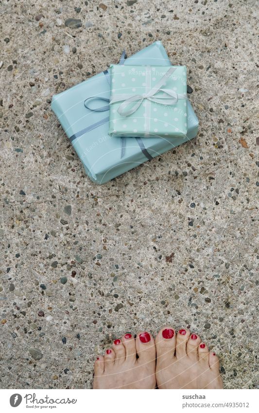 2 gifts (with feet) Birthday Christmas presents Birthday gifts Packaged gift wrapping Ribbon Street Asphalt Barefoot feminine Painted toenails Toes Nail polish