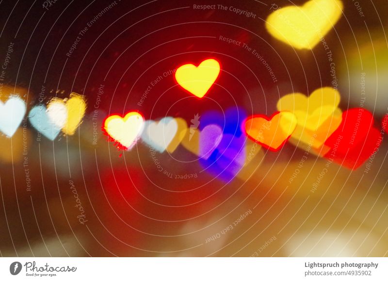 Heart-shaped bokeh seen through a window. abstract heart-shaped light romance love - emotion christmas valentine's day blur holiday bright valentine card gold
