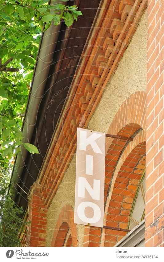 Sign with KINO on old ornate brick house Cinema Brick-built house Brick building Film Theatre Film industry running picture when the pictures learned to walk