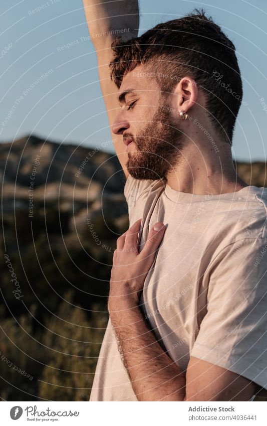 Man raising arm with dry flower man arm raised blue sky countryside weekend summer fragile calm male young cloudless sky hill flora bloom daytime peaceful