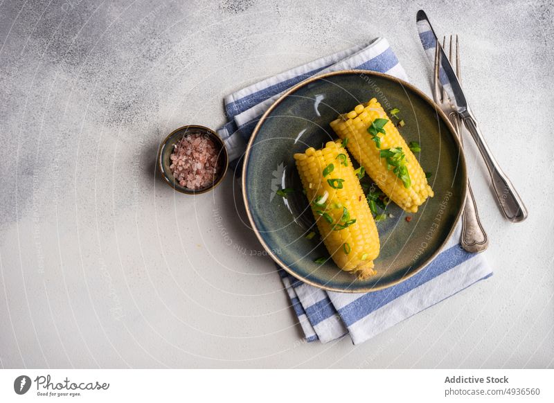 Boiled corn with salt and green onion boiled bowl cooked diet eat food healthy himalayan salt juicy meal corncob organic pink salt served plate tasty vegan