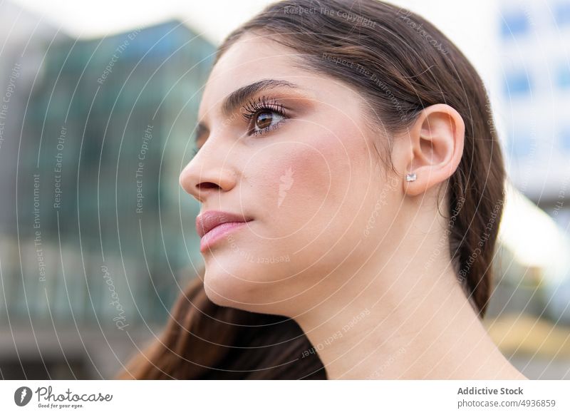 Feminine young lady smiling against modern buildings woman style model gorgeous portrait feminine confident street city female close up individuality