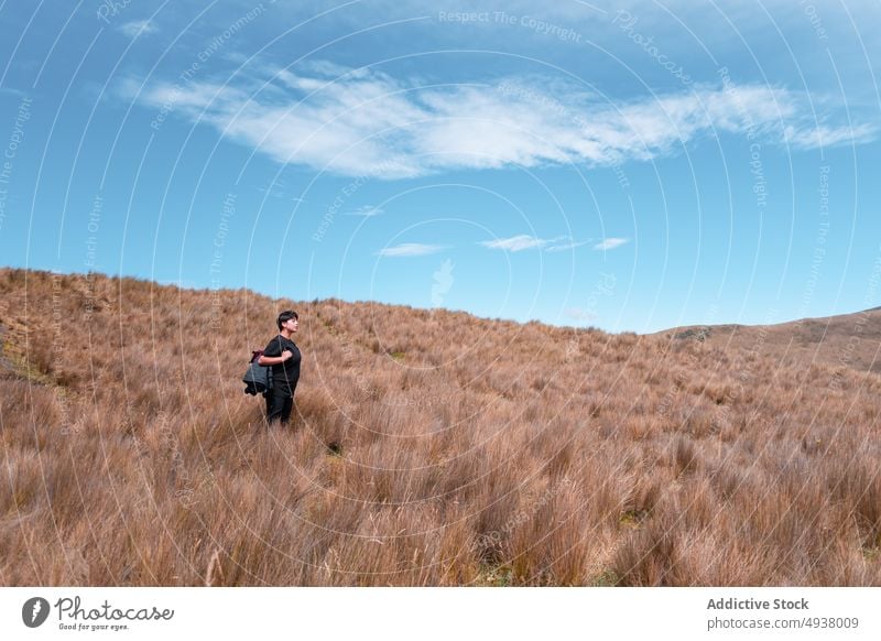 Traveling woman in dried field in mountains traveler grass admire explore highland meadow female summer nature backpack environment wanderlust dry tranquil