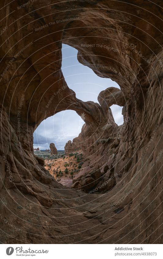 Stone arches on cloudy day in desert stone formation sky weather rough arid nature double arch arches national park moab utah usa united states america rock