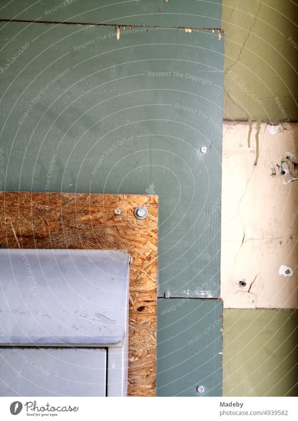 Mailbox on chipboard with rain pipe in natural colors and pastel shades of a house entrance in Oerlinghausen near Bielefeld on the Hermannsweg in the Teutoburg Forest in Ostwestfalen-Lippe