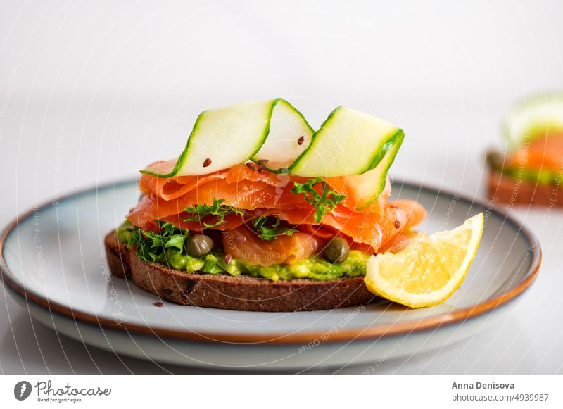 Toast with avocado and salmon toast smoked salmon mashed bread lunch breakfast fresh food fish healthy delicious snack gourmet meal slice sandwich cheese