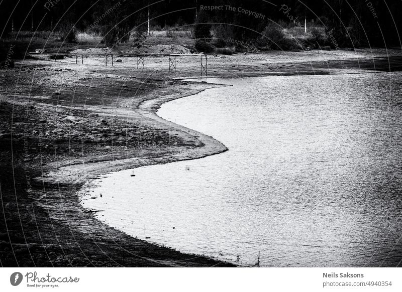 low water level river dry weather dryness aridity bank shore edge bridge footbridge deserted Latvia Daugava bending river bank nature summer landscape